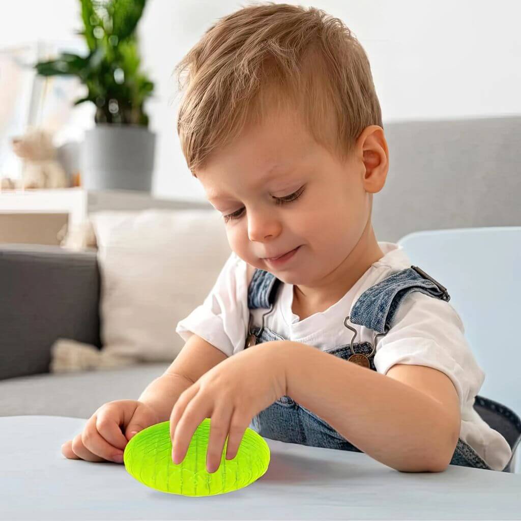 Child playing with a green magic morphoid