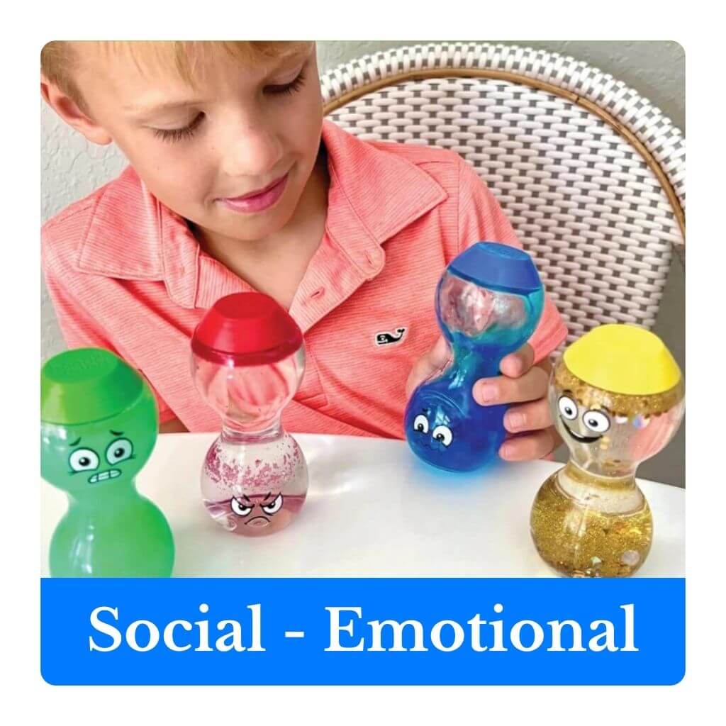 Child playing with colorful toys labeled 'Social - Emotional' on a white surface.