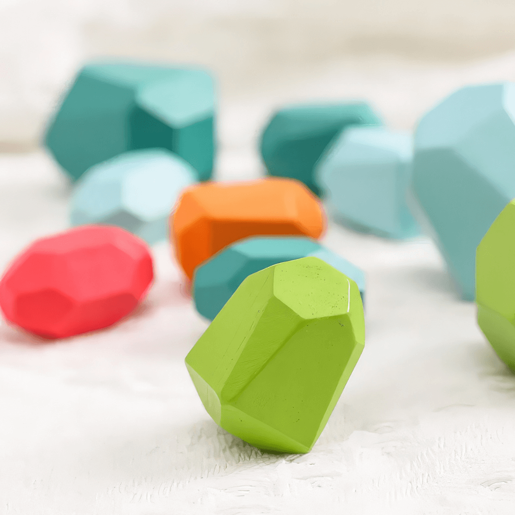 Colorful wooden stacking stones close up on white background