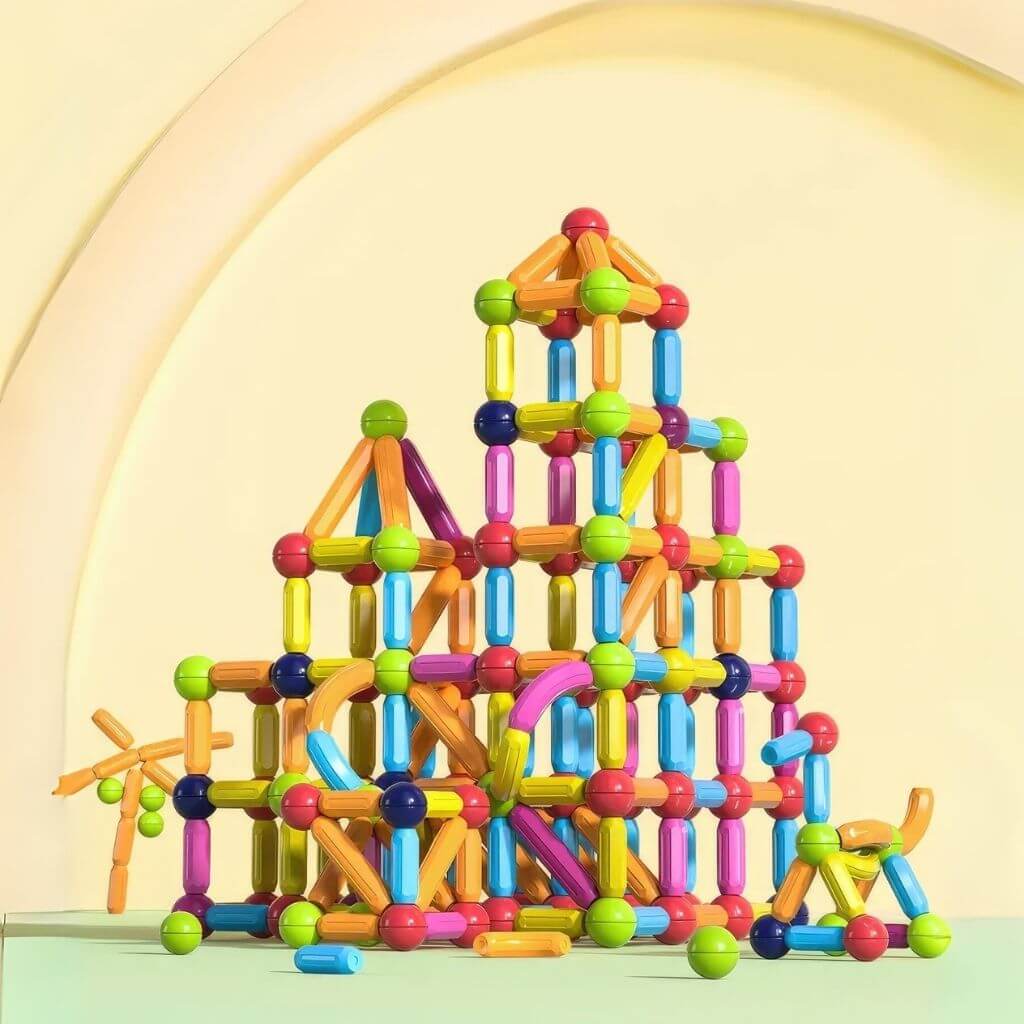 Complex construction made of magnetic toys balls and rods on a yellow background