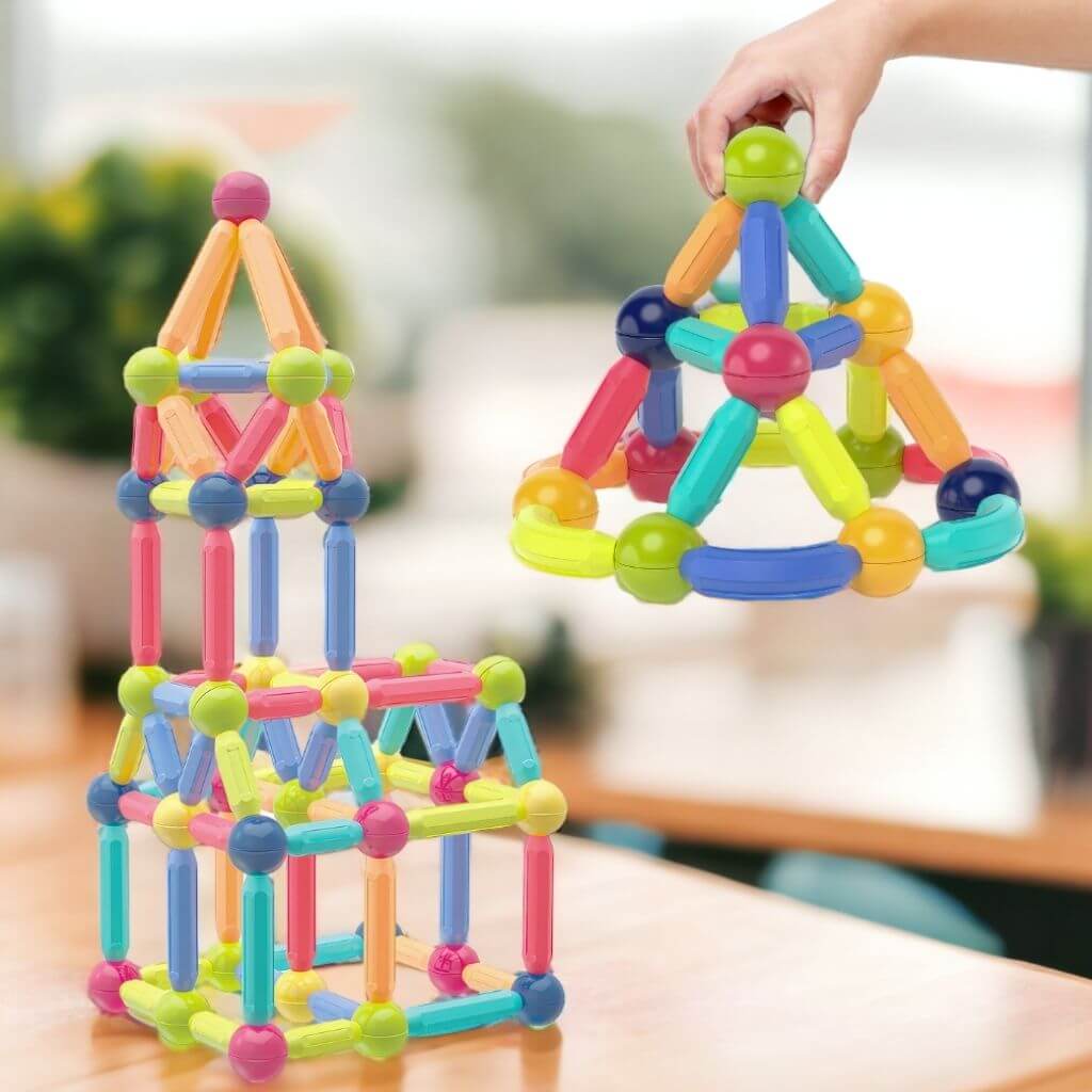 Constructions made of magnetic blocks on a light wooden table