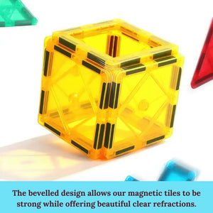 Cube made of yellow magnetic tiles on white background
