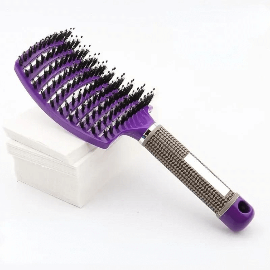 Detangling hair brush purple on a stack of white paper