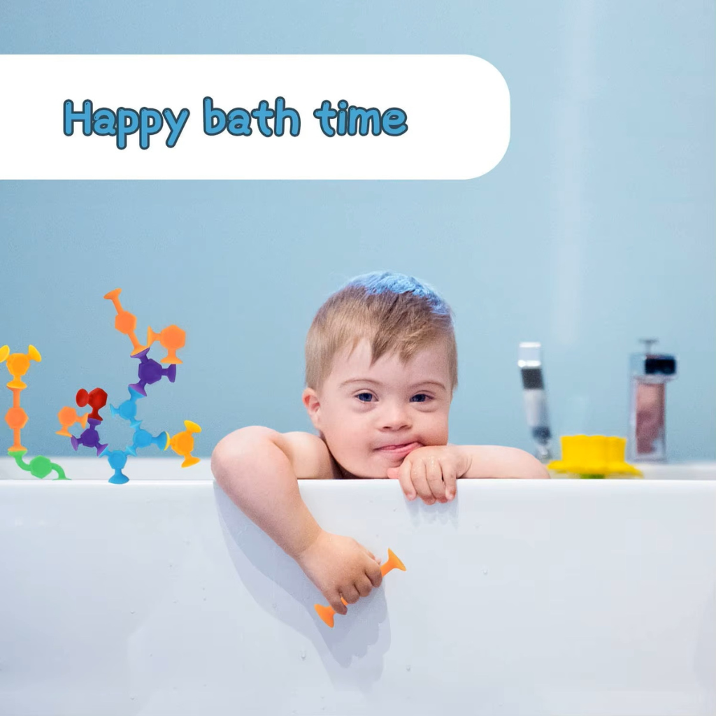 Down syndrome toddler playing with suction construction toys