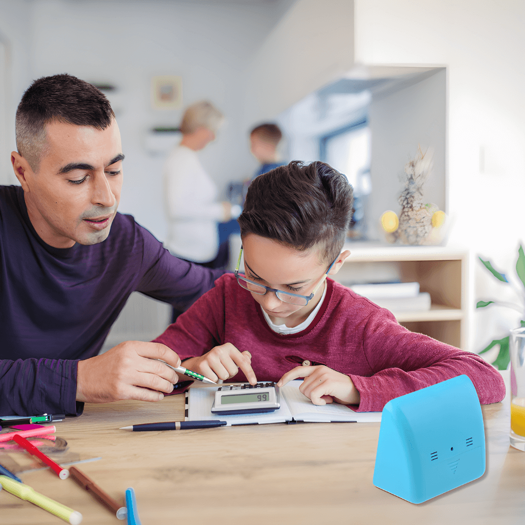 Father helping sone do his homework at the kitchen table with a time timer