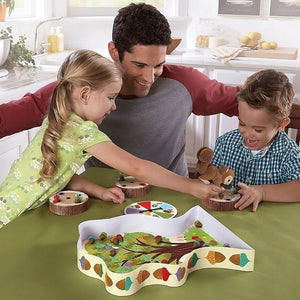Father and two children playing The Sneaky, Snacky Squirrel Game! by Educational Insights at a kitchen table