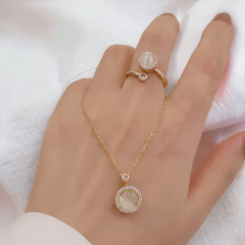 Fidget jewellery for adults necklace and ring with opal spinning top on a woman's hand