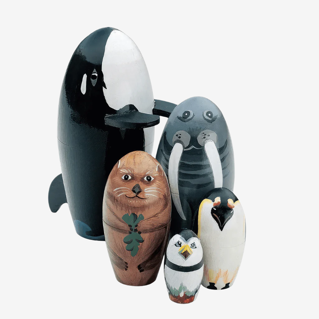 Five babushka nesting dolls antarctic animals on white background