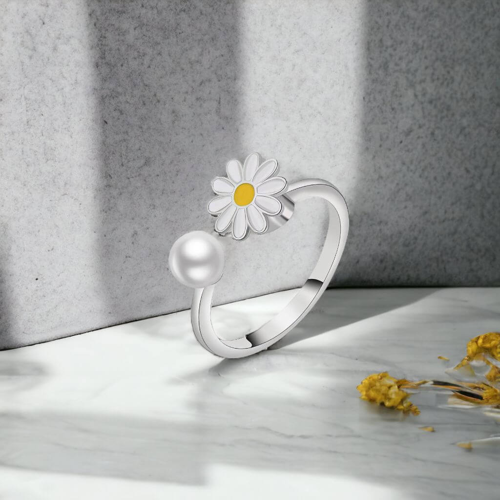 Flower pearl ring silver adjustable on a grey background with shades