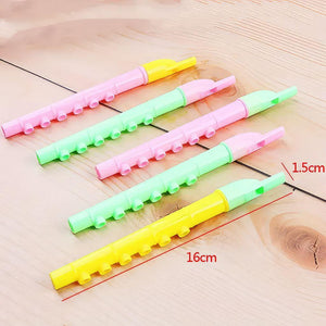 Yellow, green and pink flute whistles close up