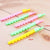 Yellow, green and pink flute whistles close up