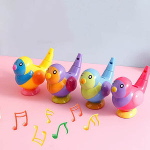 Four bird shaped whistles on pink background