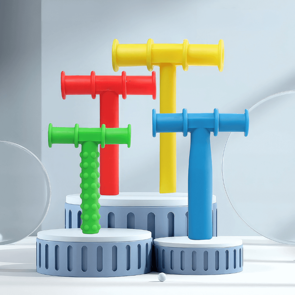 Four chewy tubes for speech therapy on grey props