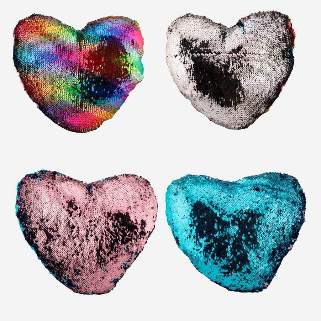 Four heart shaped sequin cushions on white background