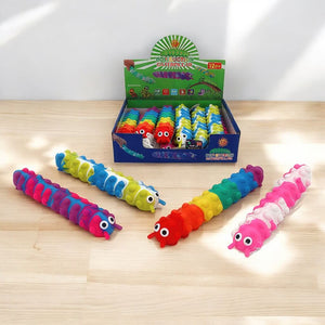 Four pop it fidget toys caterpillar and box on a wooden table