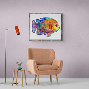 Framed fish puzzle mounted on a wall above a retro armchair
