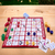 Game board, cards and chips from Sequence for Kids Game on a wooden table