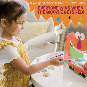 Girl playing Feed the Woozle cooperative board game by Peaceable Kingdom