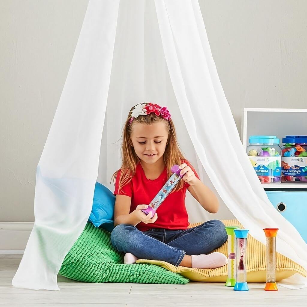Girl playing with a sensory fidget tube from hand2min under a white tent