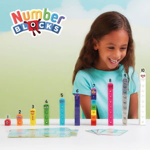 Girl smiling at the numberblocks mathlink cubes one to ten on a white table