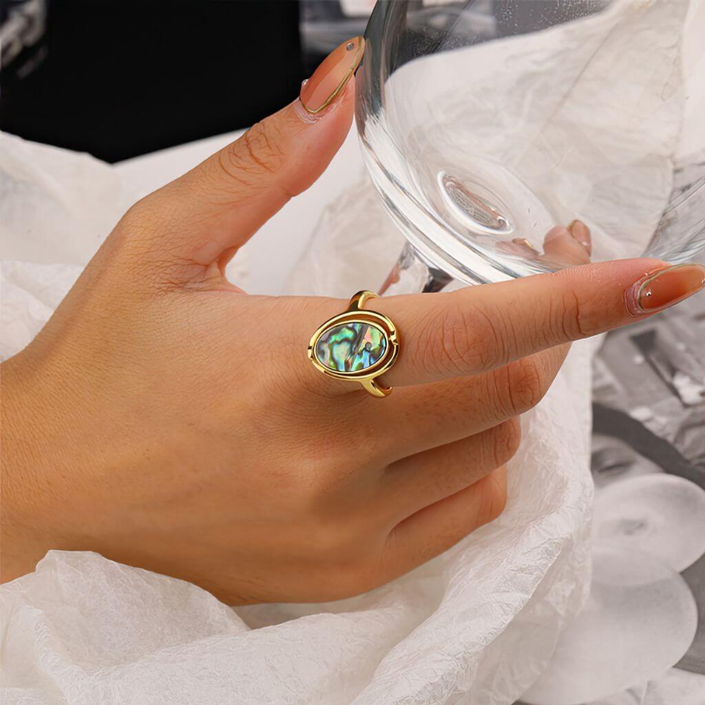 Gold abalone rotating ring on a woman&#39;s hand
