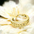 Gold fidget ring on a white flower