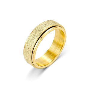 Gold spinning ring on white background