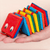 Hand holding a Jacob's ladder wooden toy