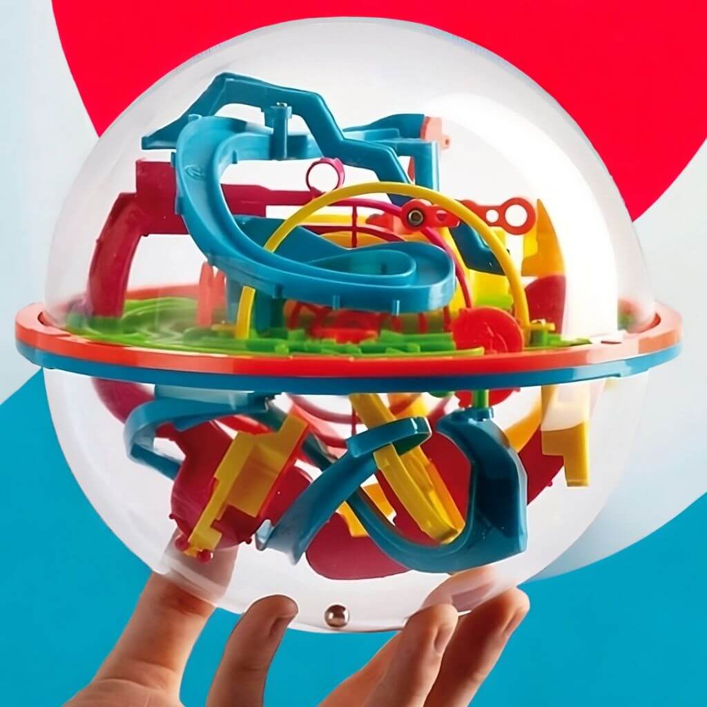 Hand holding an addict a ball maze 2 game with 138 stages on a colorful background