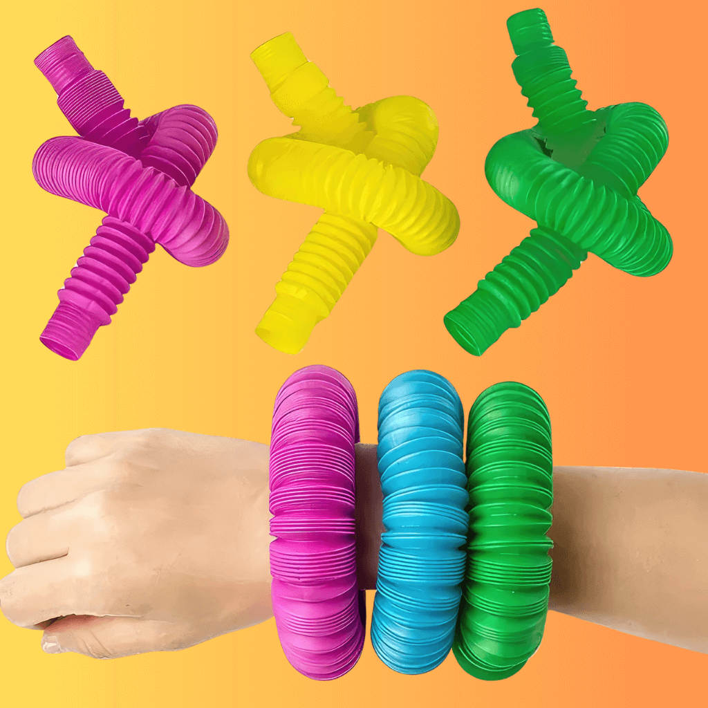 Hand wearing three pop tubes on an orange background