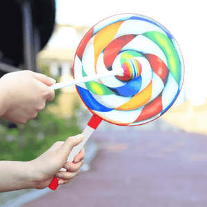 Hands beating a Lollipop drum on blurred background