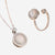 Jewelry set with a necklace and ring featuring cubic zirconia and opal gemstones on a white background.