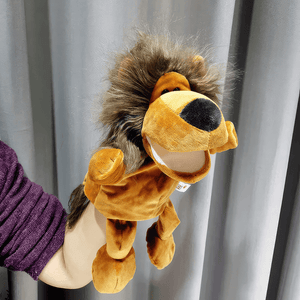 Lion hand puppet on woman's hand on grey background