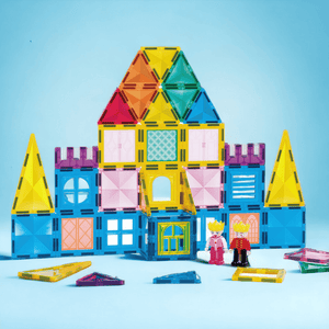 Magnetic tiles castle and figurines on blue background