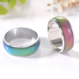 Mood rings with turquoise and pink bands close up