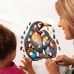 Mother and daughter making a penguins jigsaw puzzle at a table