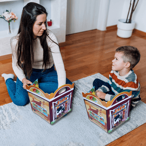 Mother and son playing barrier games  on the floor with farm reusable sticker books