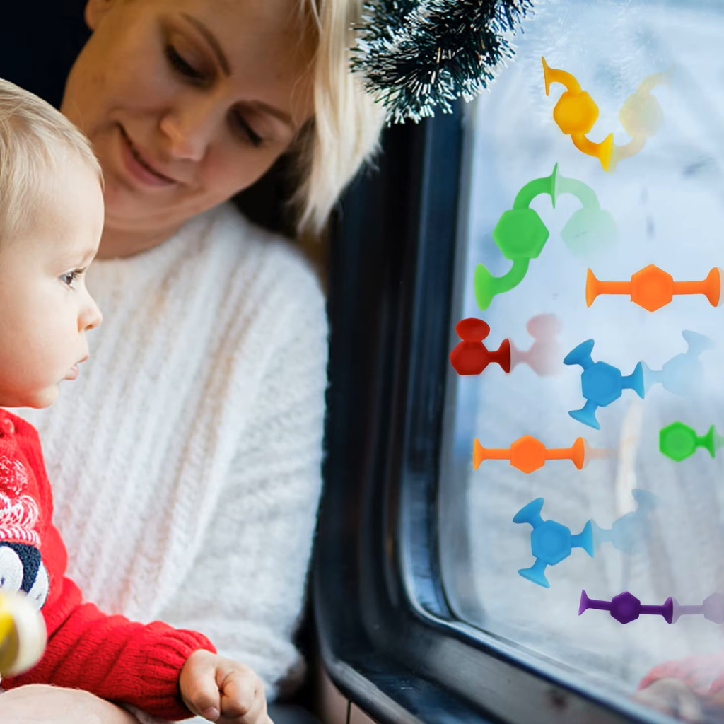 Mother and toddler playing with suction construction toys