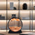 Moving sand art orange in front of a display shelves unit