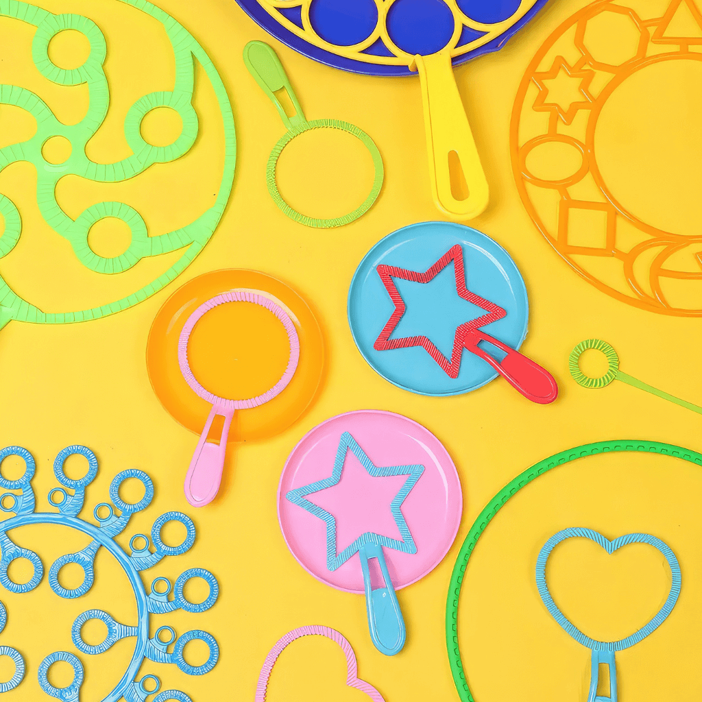 Multicoloured bubble wands on yellow background
