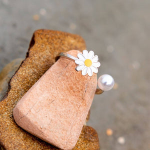 Pearl ring adjustable on a grey rock close up