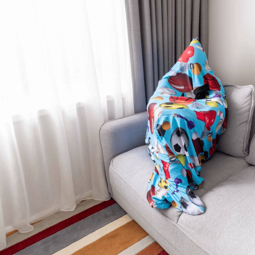 Person wrapped in a body sock sensory on a sofa