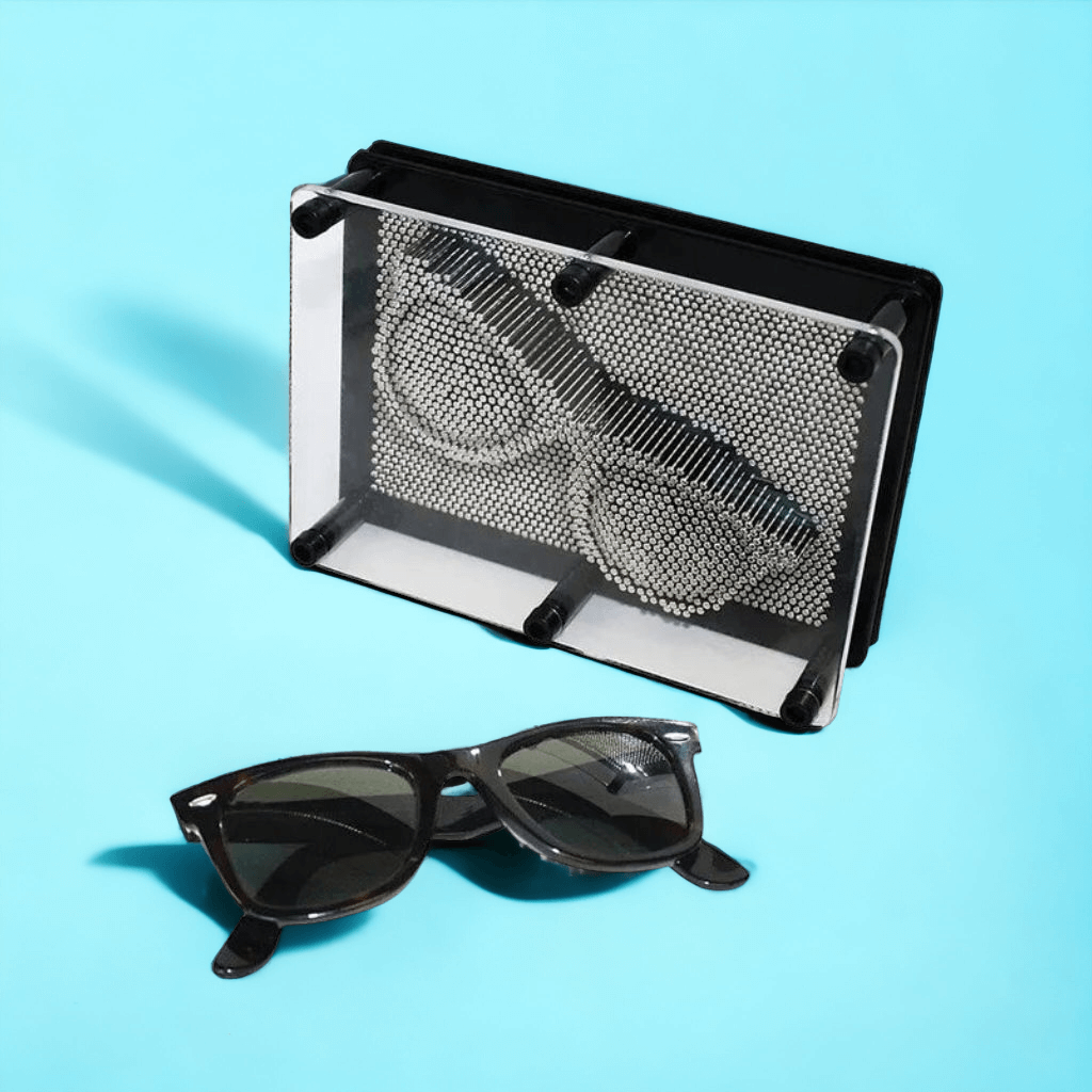 Pin art board next to sun glasses