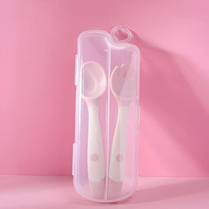 Pink flexible spoon and fork in a travel case on pink background