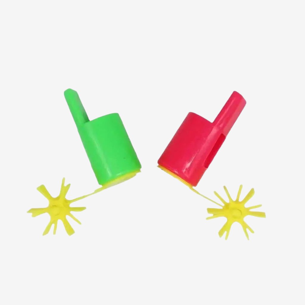 Red and green propeller whistles on a white background