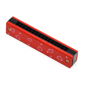 Red hearts wooden harmonica for kids on a white background