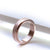 Rose gold stainless steel ring for fidgeting on white background