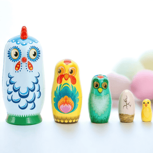 Russian nesting dolls Babushka chickens with pastel eggs in background