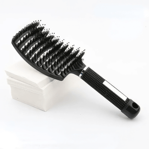 Sensory hair brush black on a stack of white paper