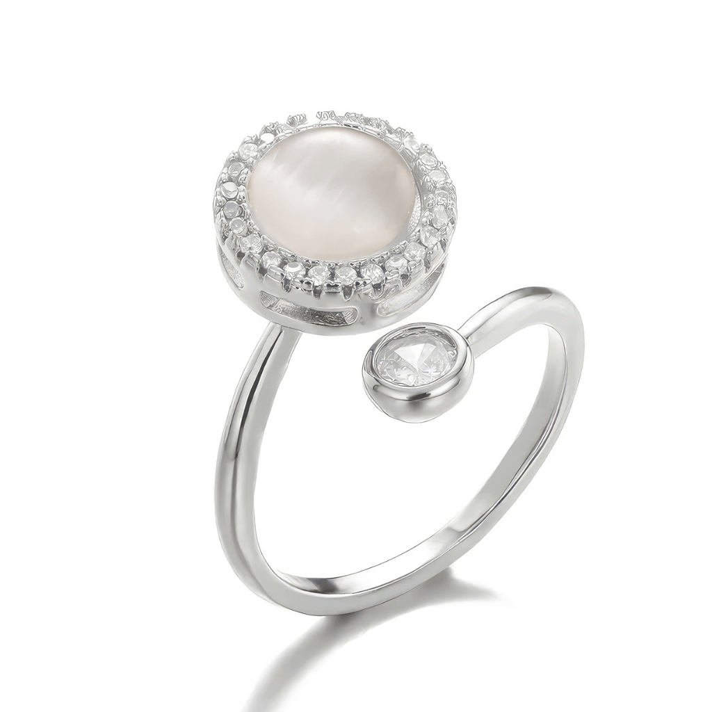 Silver fidget ring with opal spinning top on white background